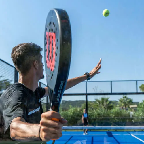 Man playing tennis enhancing fitness at 7Pines Resort