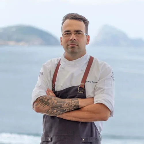 Chef Andrés Fernández at 7Pines Resort Ibiza, poised beside a scenic lake