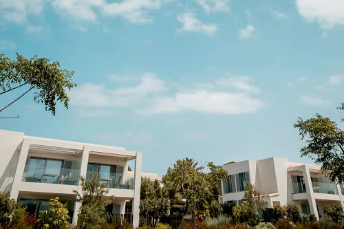 7Pines Resort scenic white buildings among lush trees under blue sky