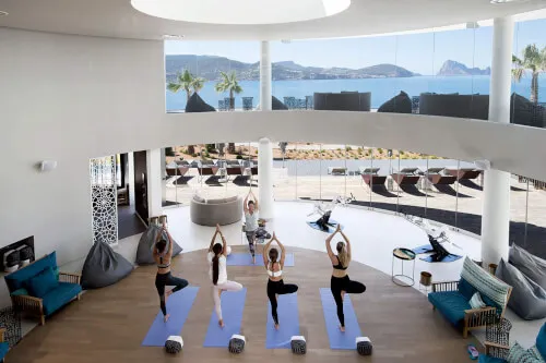 Group yoga class at 7Pines Hotels & Resorts, personalized for guests