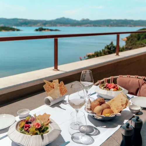Brunch table with food platter and wine at 7Pines Hotels & Resorts
