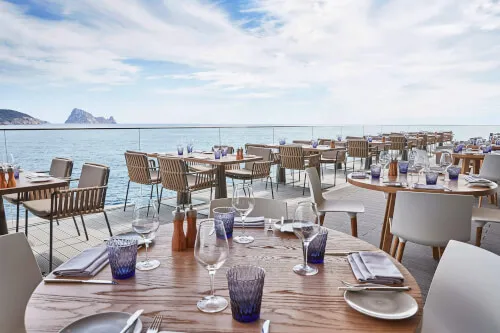 Elegant table setup for fine dining at 7Pines Resort Ibiza overlooking the ocean
