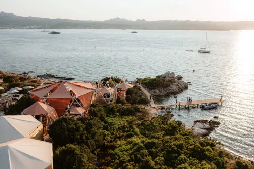 Tents by the sea at 7Pines Resort Ibiza, encapsulating the Mediterranean lifestyle of Cone Club