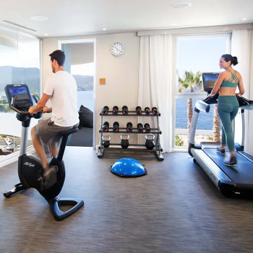 Couple exercising at 7Pines Hotels gym, embodying a premium fitness experience